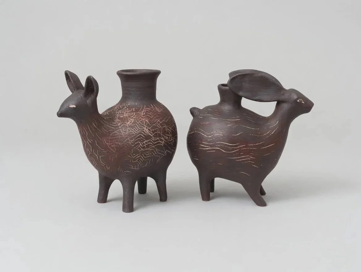Dark brown coyote and rabbit askos vessels with Pre-Columbian influence.