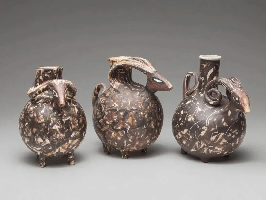 Pair of bulbous black ram-form askos vessels in burnished Etruscan bucchero style.